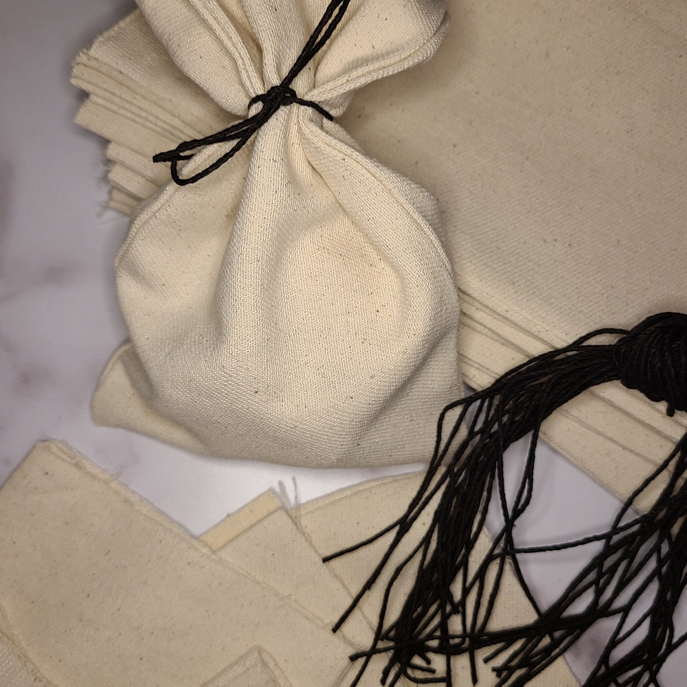 20 pack organic cotton blank Halloween treat bags with closure strings.